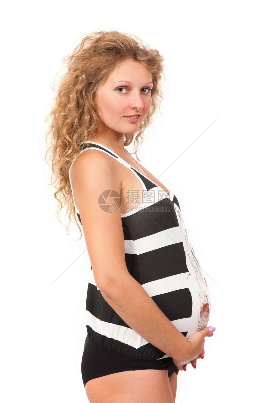 孕妇在抚摸她的肚子腹部父母情感白色成人女性生活妈妈婴儿衣服图片