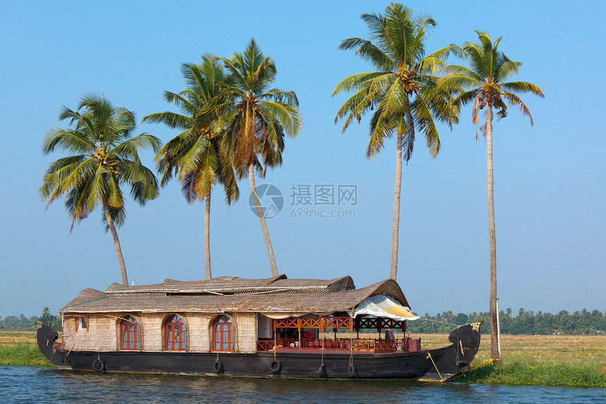印度喀拉拉腊背水上的豪船运河血管日落巡航死水热带旅行反射闲暇运输图片