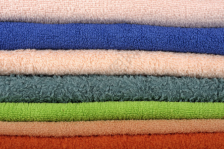 彩色的毛巾织物团体纺织品棉布吸水性折叠绿色卫生橙子蓝色背景图片