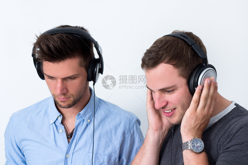 听音乐的两位朋友快乐耳机面孔友谊享受白色青少年乐趣成人音乐图片