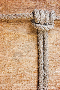 由旧绳子制成的框架招牌棕色样本木板蕾丝节点旅行绳索背景图片