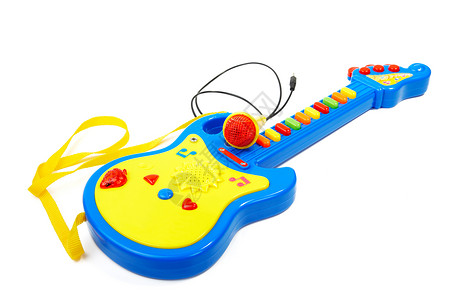 蓝色吉他儿童玩具吉他和麦克风在白色的背面被孤立黄色蓝色幼儿园闲暇玩物土地塑料游戏音乐童年背景