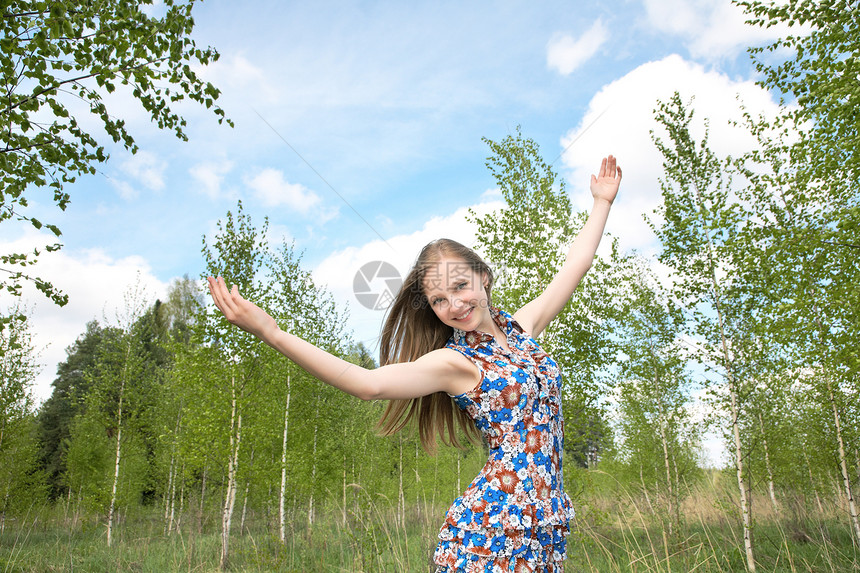 举起手来对着天空的女孩晴天桦木微笑公园蓝天喜悦享受金发女性青年图片
