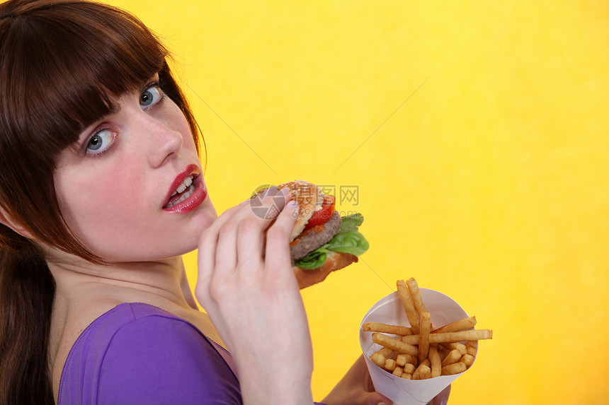 女人吃汉堡和薯条馅饼食物晚餐美食洋葱饮食油炸盘子边缘筹码图片