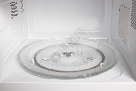 微波炉内视图厨房技术白色烹饪电气工具器具盘子转盘微波背景图片