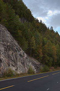 路边的岩石和树林背景图片