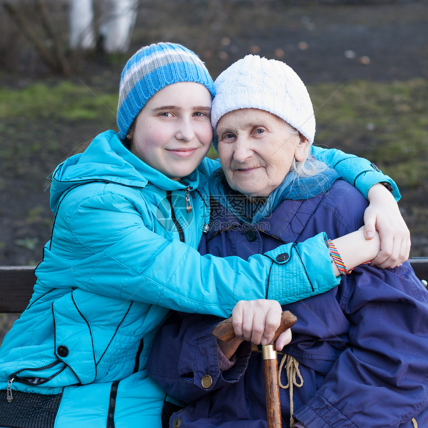 孙女抱着她的外祖母拥抱温暖老人快乐女性祖母友谊家庭肩膀幸福图片