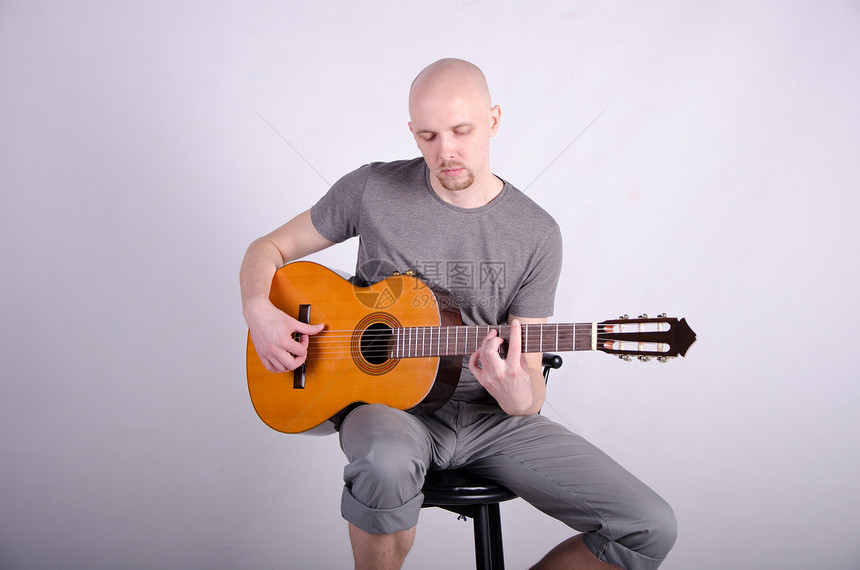 拿着吉他光秃秃的好人星星头发音乐工作室吉他手演员金属男人玩家帽子图片
