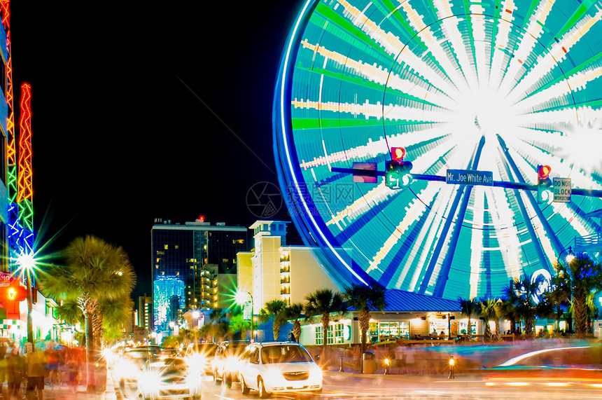 在美特尔海滩的大海滩上乐趣光迹夜生活旅行运输大道娱乐摩天轮电气天轮图片