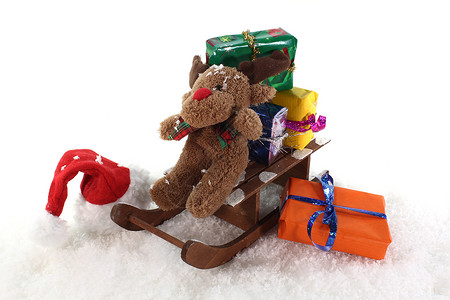 带礼物的雪橇乐趣魔法玩具圣诞礼物惊喜帽子公仔麋鹿丝带毛绒背景图片