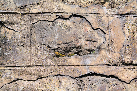 古老的石墙岩石建筑正方形边界鹅卵石假山裂痕花岗岩活动材料背景图片