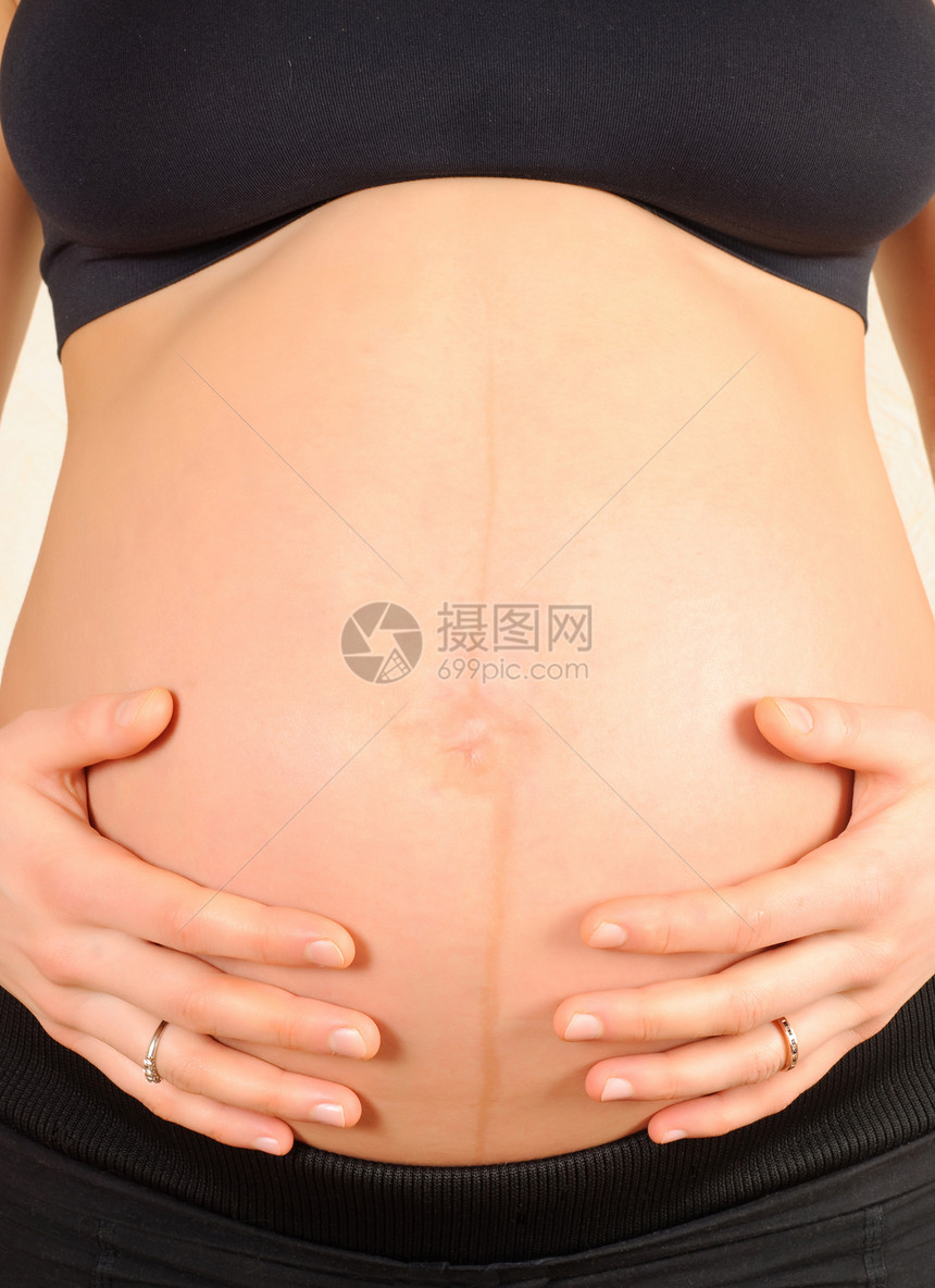 怀着肚子的怀孕妇女药品弯头母性身体生活女性手指分娩妈妈婴儿图片