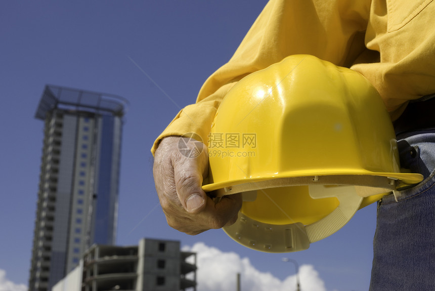 正在施工中建筑联盟男性工人头盔工作男人牛仔布蓝色就业图片