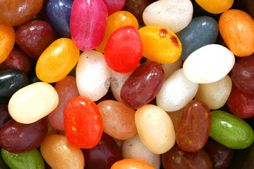 色彩多彩的糖果黄色橙子绿色红色蓝色棕色食物白色图片