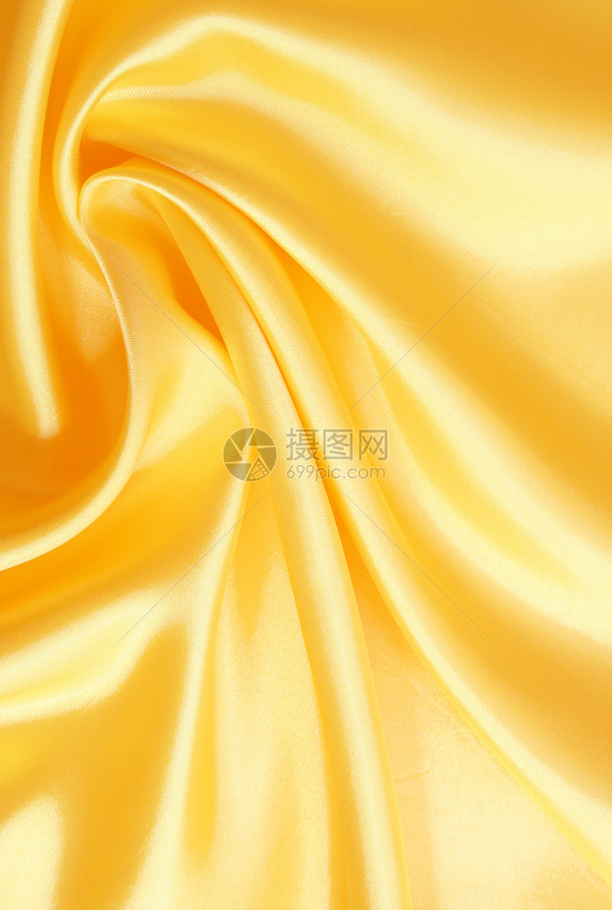 平滑优雅的金金丝绸投标纺织品曲线织物涟漪折痕黄色布料丝绸海浪图片