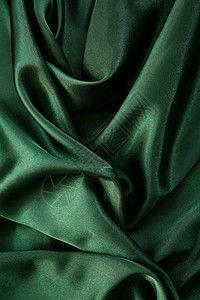 平滑优雅的深绿色丝绸作为背景背景图片