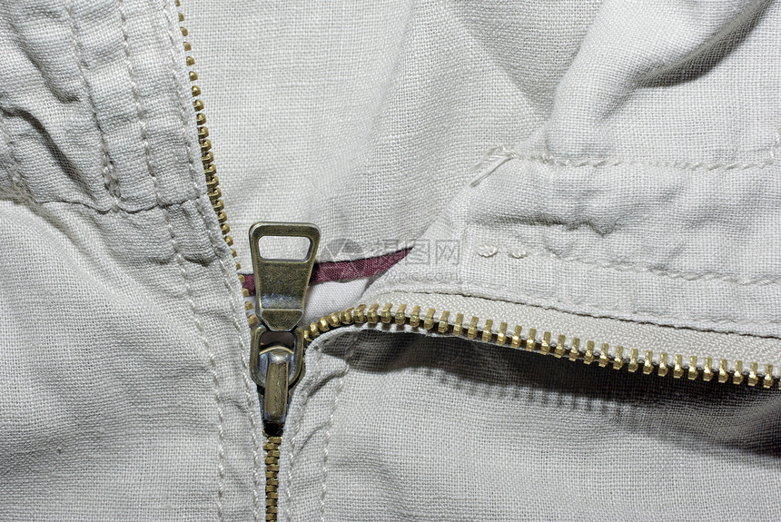 具有拉链背景的抽象Beige denim纺织品接缝裙子安全金属紧固件材料裤子中心织物牙齿图片