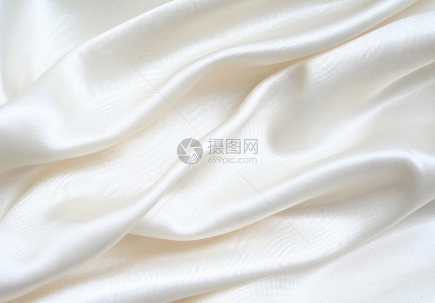 平滑优雅的白色丝绸作为背景织物寝具奢华投标涟漪生产衣服版税婚礼材料图片