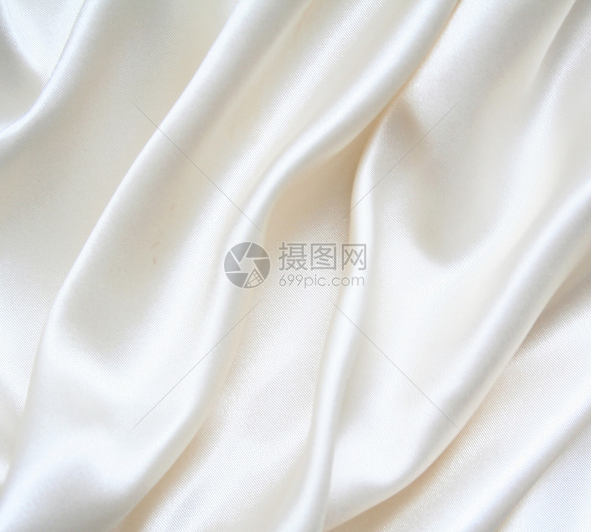 平滑优雅的白色丝绸作为背景奢华布料海浪寝具投标新娘材料折痕版税衣服图片