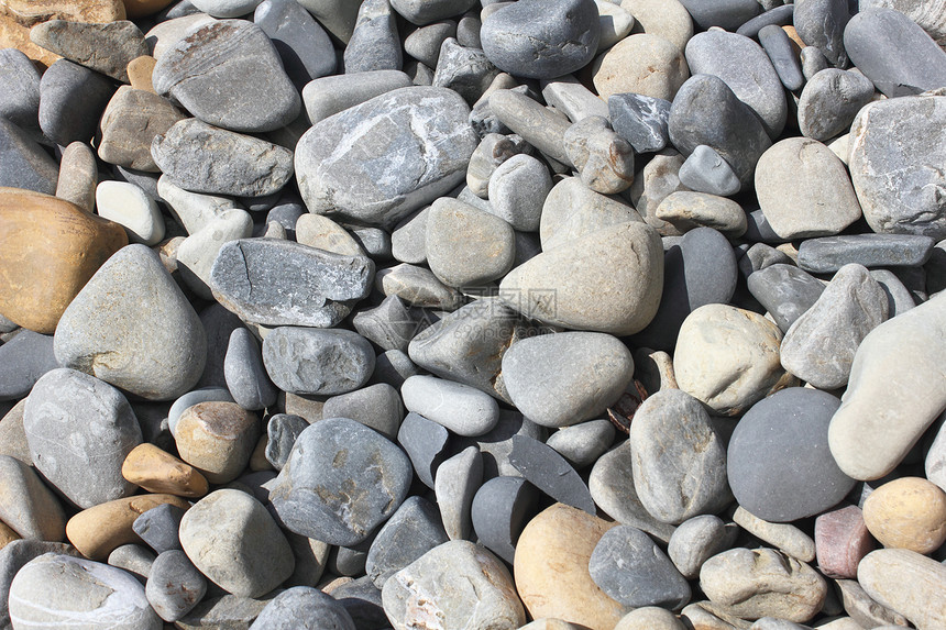孔框背景背景岩石卵石石头阳光海滩海岸圆形图片