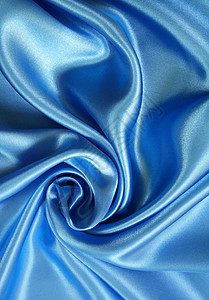 平滑优雅的深蓝丝绸银色布料材料曲线纺织品折痕海浪丝绸投标织物背景图片