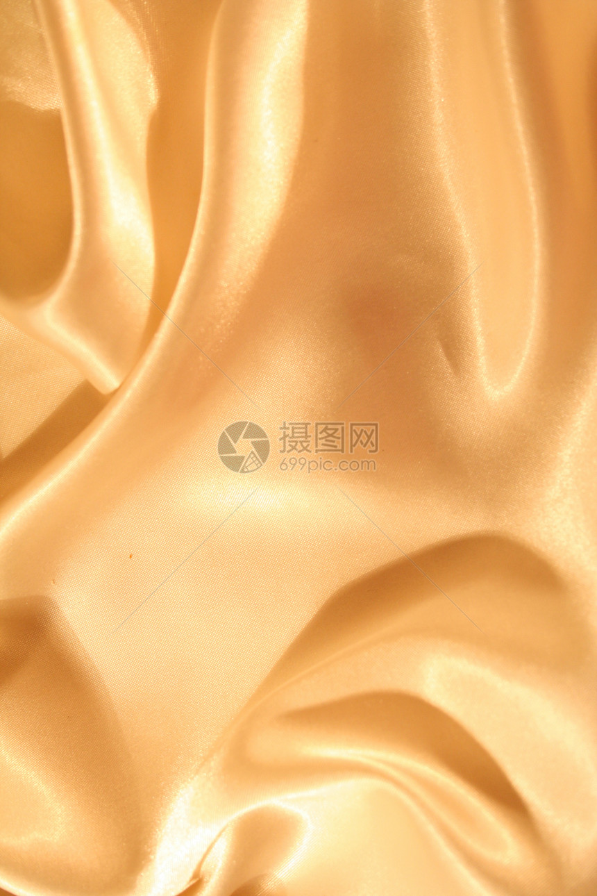 平滑优雅的金金丝绸折痕织物涟漪金子纺织品奢华丝绸版税布料反光图片