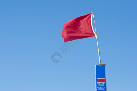红旗冲浪警告旗帜天空危险蓝色海滩飓风锦旗背景图片