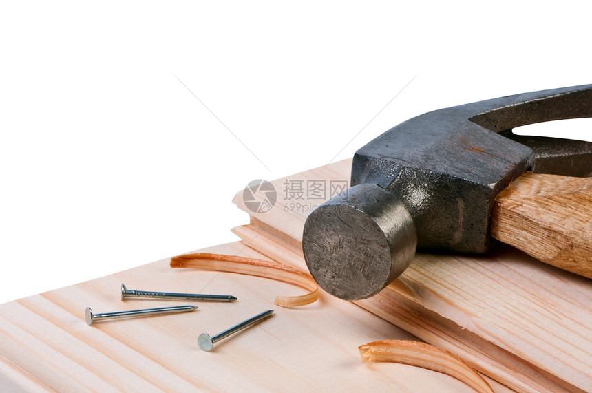 木板上的锤子和钉子 构思建筑和维修图片