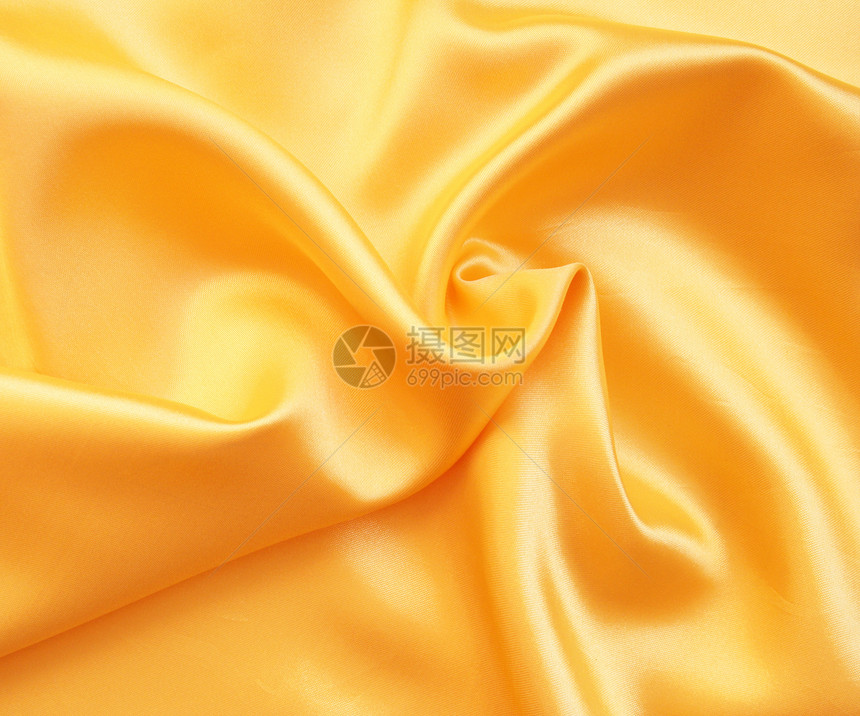 平滑优雅的金色西边作为背景投标奢华材料金子布料黄色折痕曲线涟漪织物图片