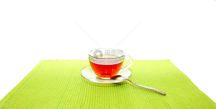 茶杯和汤匙 在绿餐巾纸上飞碟环境杯子勺子芳香盘子液体饮食伯爵饮料图片