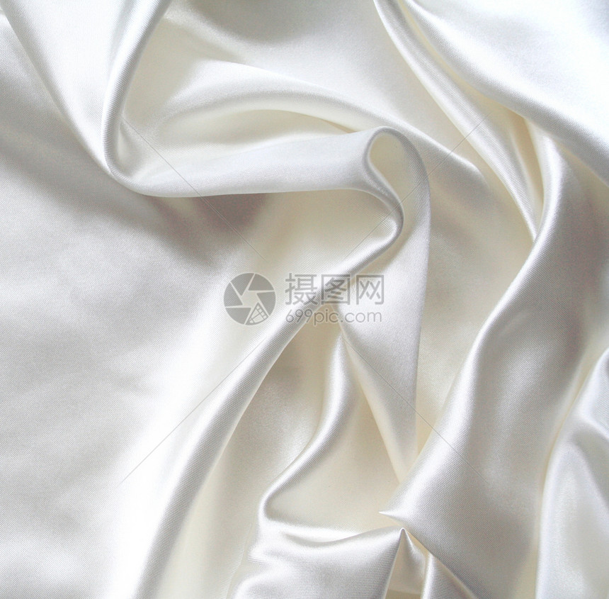 平滑优雅的白色丝绸作为背景版税婚礼奢华海浪布料投标涟漪生产衣服织物图片
