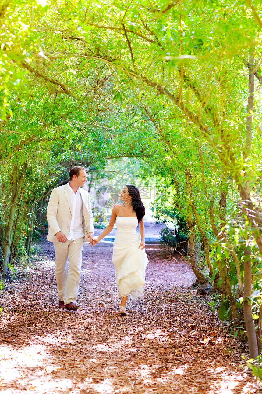 一对夫妇刚刚结婚 幸福快乐地在绿色公园跑来跑去男人女性新娘婚礼套装仪式妻子女士丈夫建筑图片