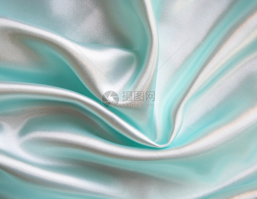 平滑优雅的蓝色丝绸作为背景布料投标曲线织物纺织品生产海浪材料感性折痕图片