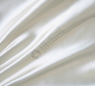平滑 优雅的白色丝绸可用作婚礼背景折痕织物曲线银色涟漪布料投标纺织品海浪新娘背景图片