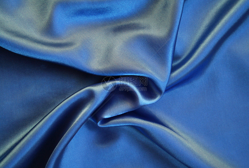 平滑优雅的蓝色丝绸作为背景投标感性曲线折痕织物布料纺织品生产版税海浪图片