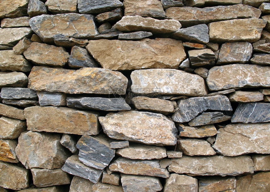 石头墙的颜色更丰富多彩 随机化石块花岗岩岩石石头石工房子砂浆历史性材料砂岩石墙图片