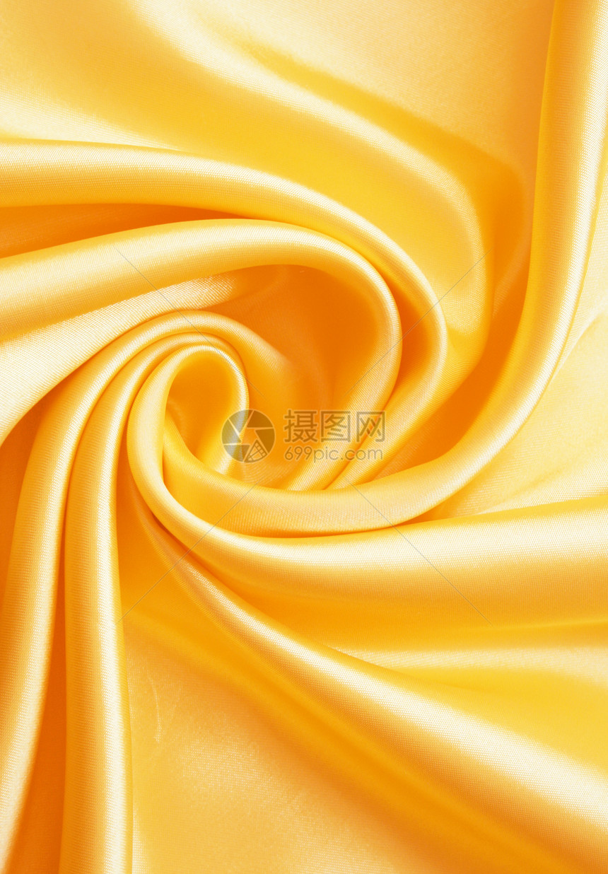 平滑优雅的金金丝绸涟漪丝绸投标黄色布料材料曲线纺织品织物感性图片