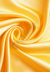 平滑优雅的金金丝绸涟漪丝绸投标黄色布料材料曲线纺织品织物感性背景图片