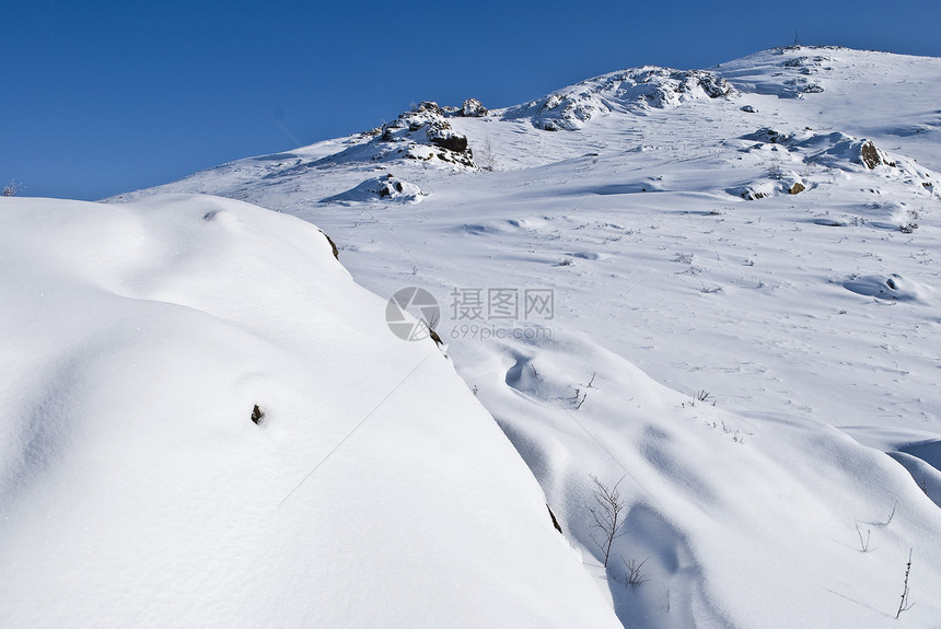 雪山蓝色白色日光天空冻结石头天气爬坡人行道图片