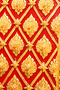 在庙墙上的金色泰国图案设计墙纸金子工艺文化装饰古董宗教寺庙建筑装饰品背景图片