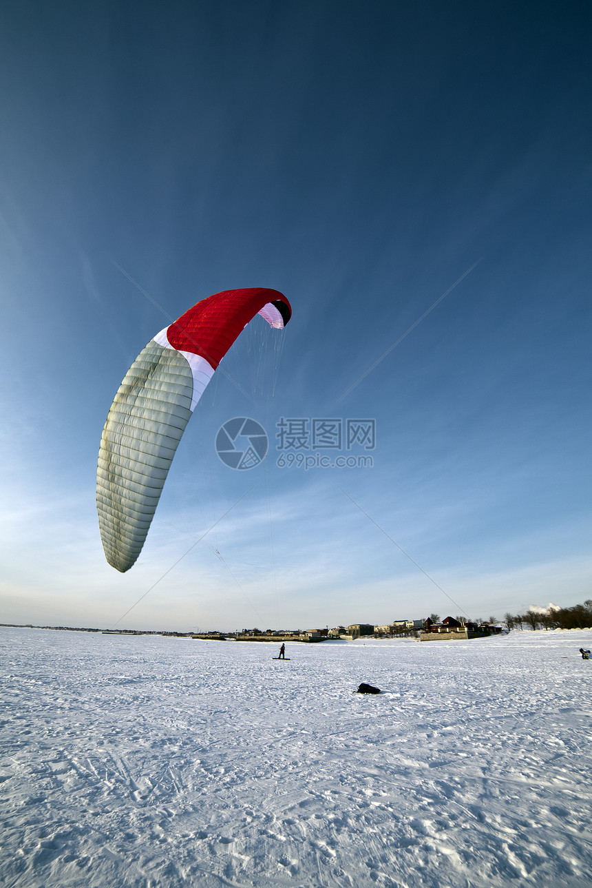 在冰冻湖上打滑衣乐趣天空空气娱乐运动员晴天男人漂浮山脉太阳图片