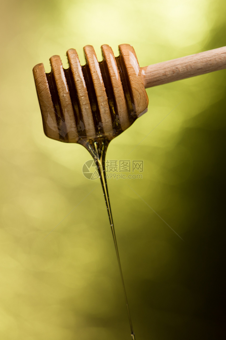 蜂蜜液体食物黄色勺子棕色图片