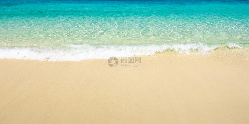 海滩的沙子假期蓝色放松太阳阳光旅行天堂海浪晴天热带图片
