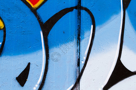 灰砖墙对面的彩色 Graffitia 艺术背景图片