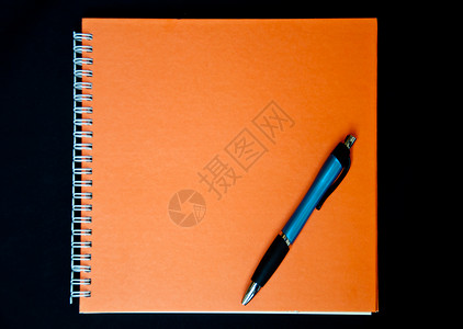 橙橙笔记本和笔摄影橙子背景图片