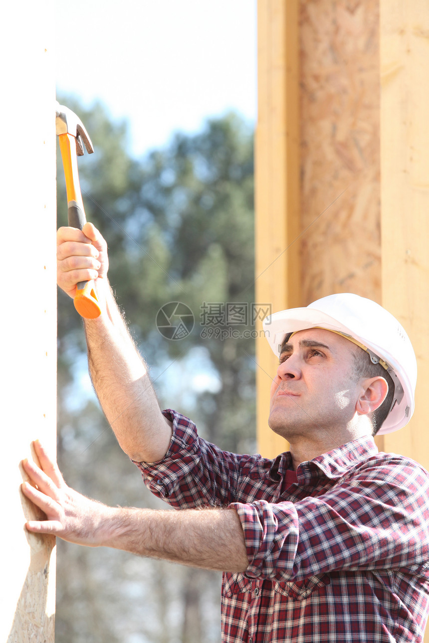 建筑工地的伐木工人住宅构造承包商房子窗户男人住房椽子光束锤子图片