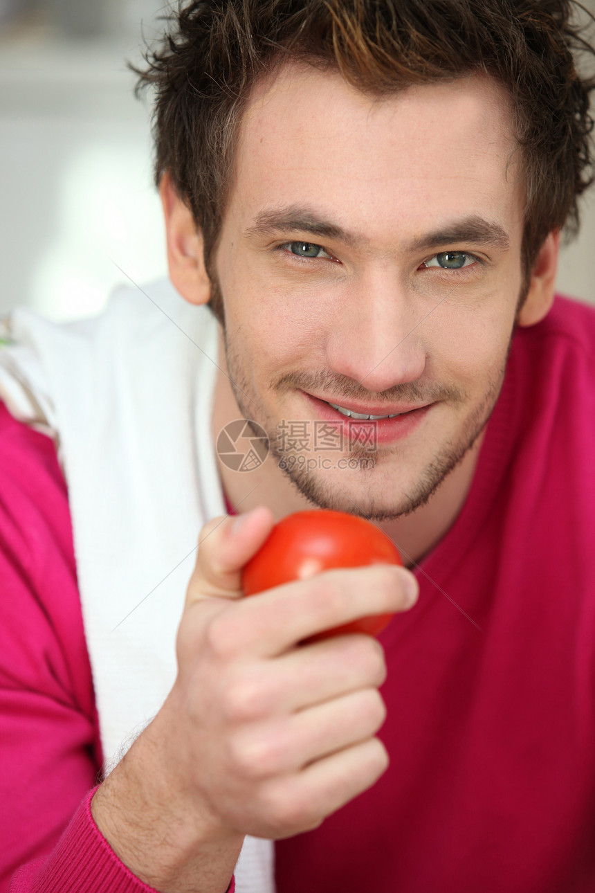一个男人拿着番茄的肖像图片