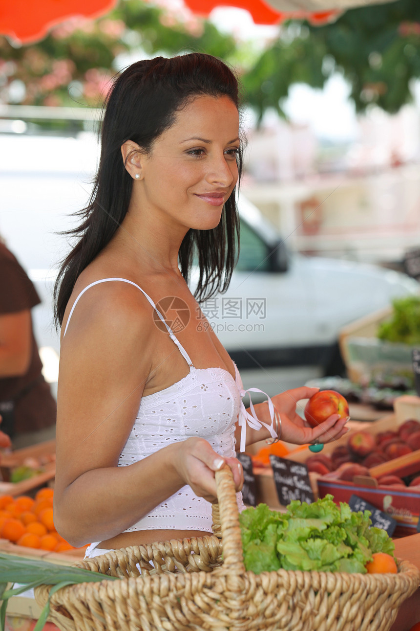 在户外市场购买水果和蔬菜的女商务人士图片