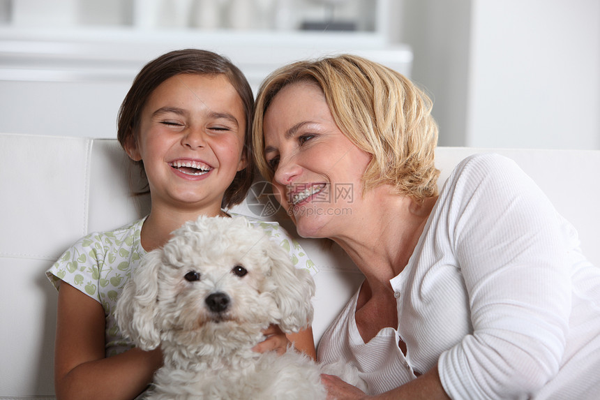 母亲 女儿和狗拥抱女孩棕色个人沙发头发女性微笑父母女士图片