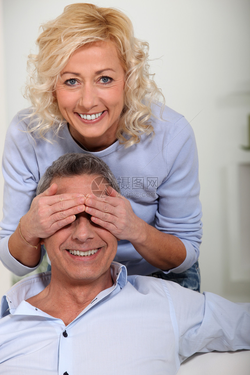 女人用手遮住丈夫的眼睛快乐白色游戏金发女郎夫妻微笑惊喜女士妻子卷发图片